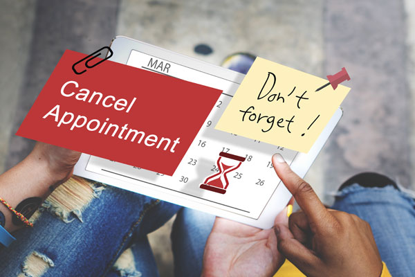 A tablet with a post it that says Don't foget and Cancel Appointment